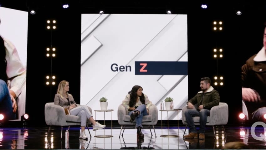 Three panellists sit in armchairs on a darkened stage, in front of a tall screen reading “Gen Z”.